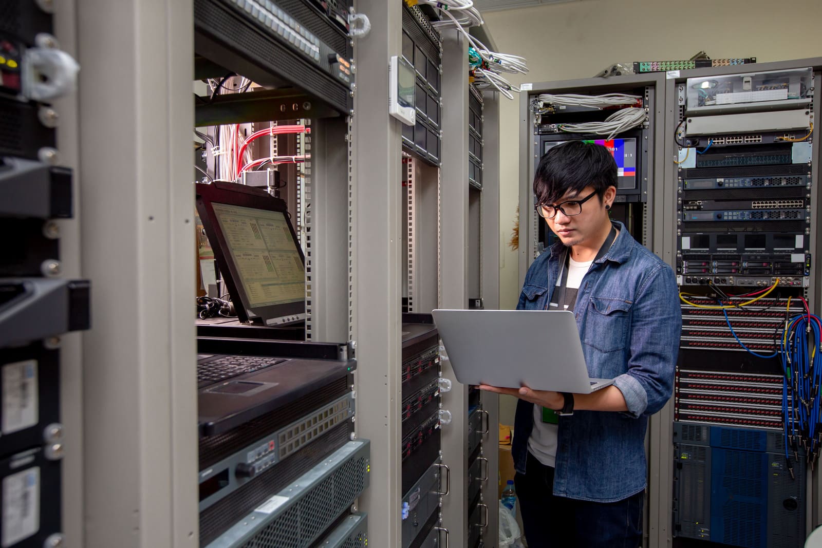 Engineer configure data center on laptop